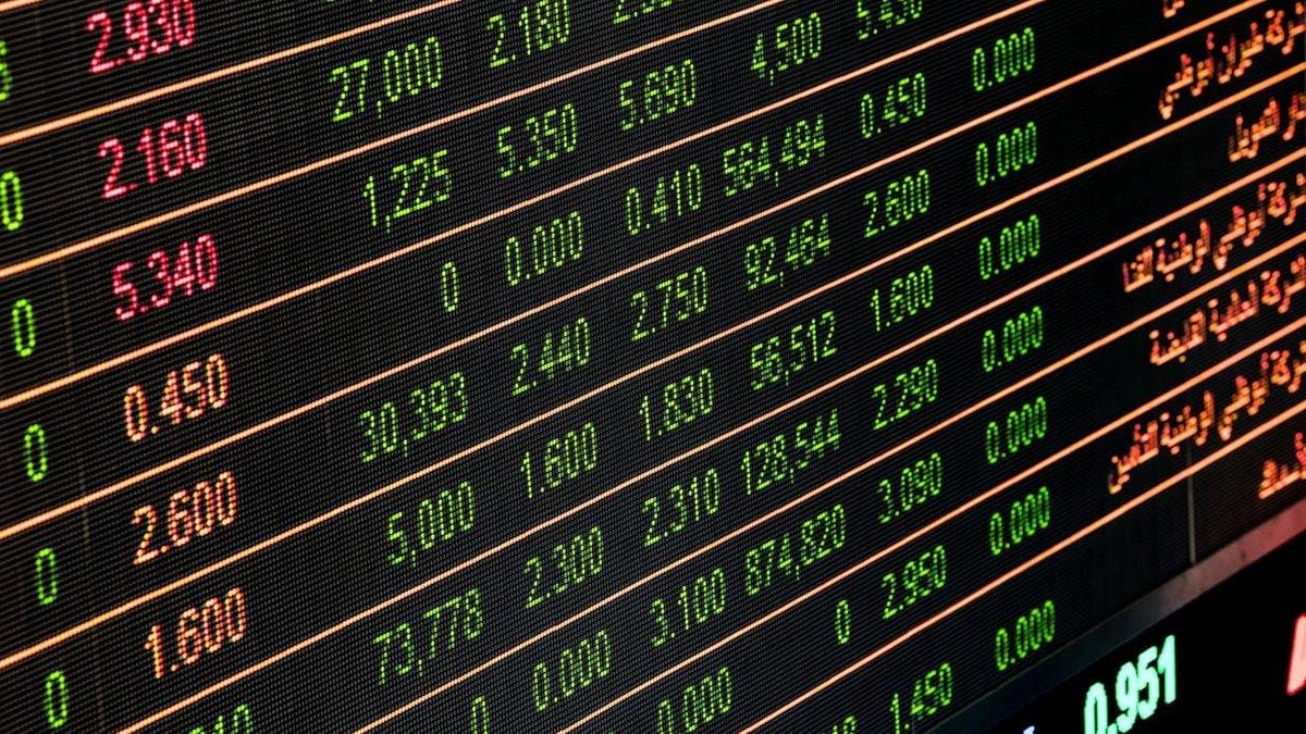 Stock market ticker board showing real-time price data and trading activity for S&P 500 and Dow Jones
