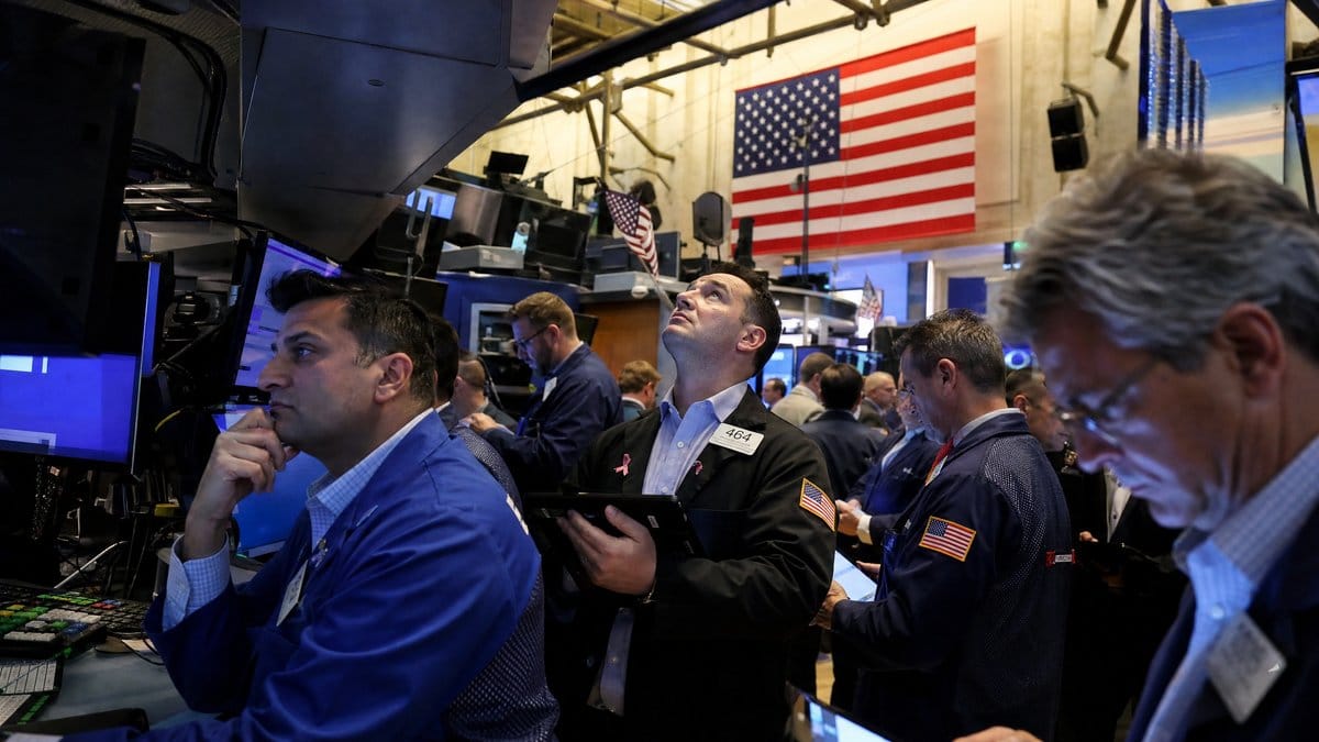 Traders on the New York Stock Exchange floor monitoring market data during an active trading session on May 20, 2026