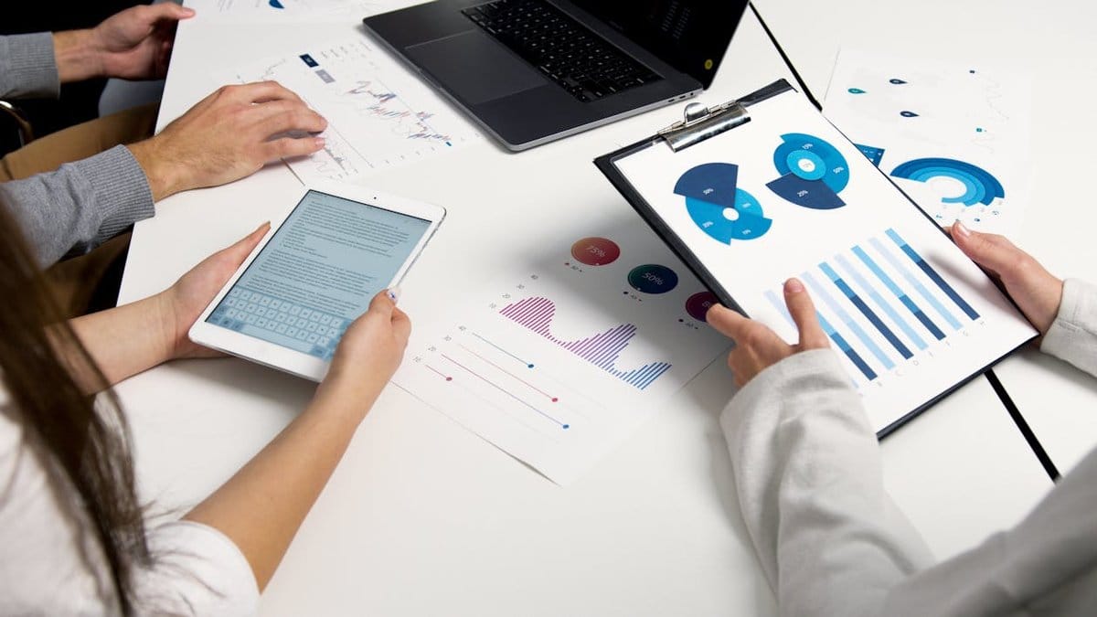 Financial analysts reviewing market performance charts and data