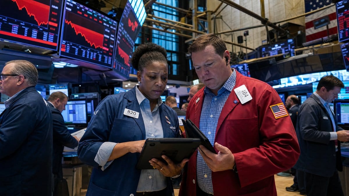 Traders on the floor of the New York Stock Exchange looking at declining market charts