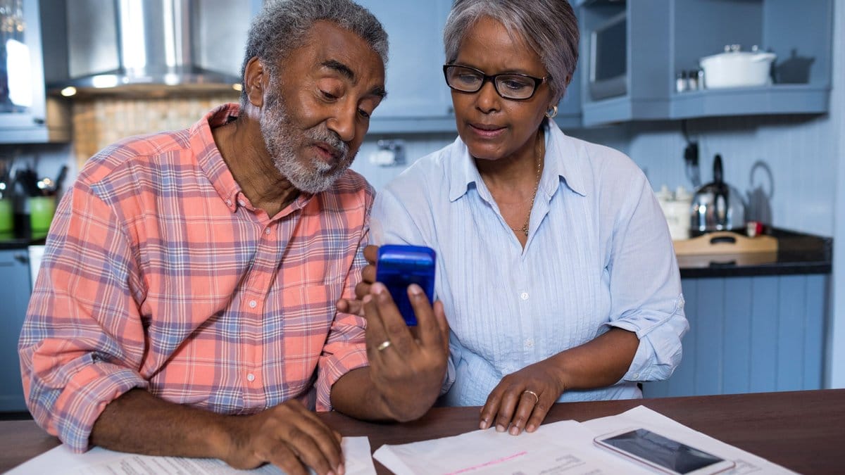 Senior couple reviewing retirement financial documents and planning their 2026 savings strategy