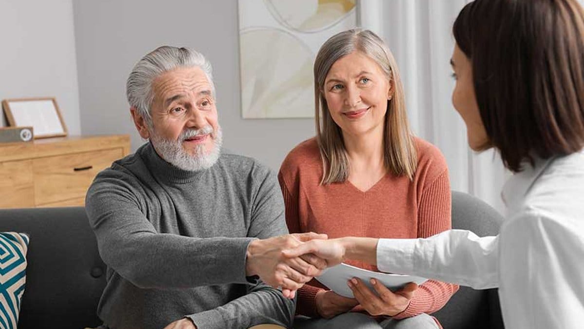 Senior couple meeting with financial advisor to review 2026 retirement contribution limits