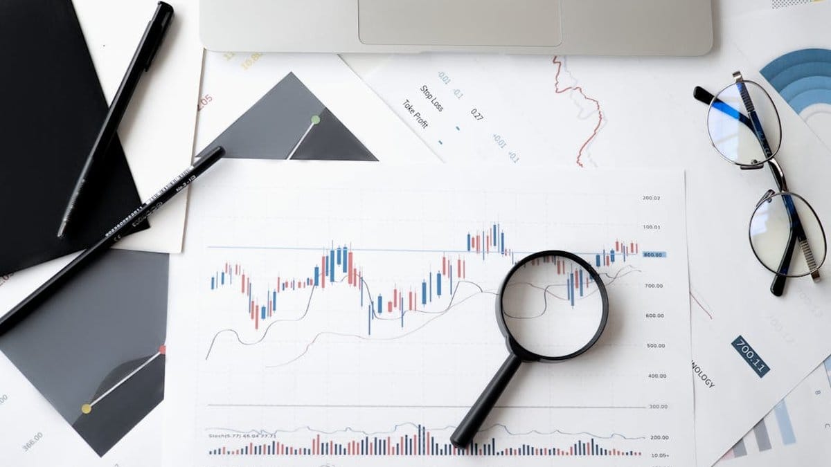 Financial analyst reviewing stock market charts and candlestick patterns for investment analysis