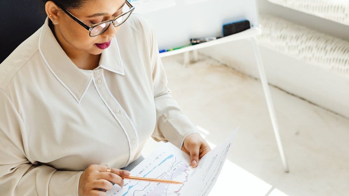 Financial analyst reviewing earnings data and market charts