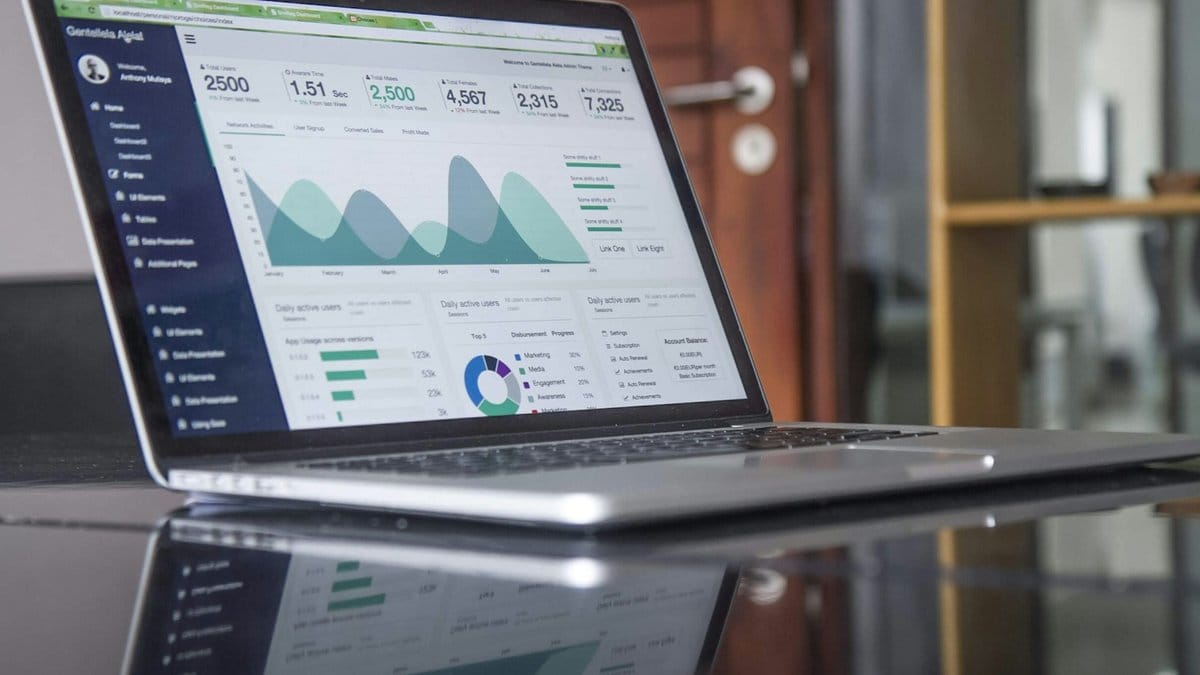 Financial data analytics dashboard on laptop screen showing corporate earnings metrics