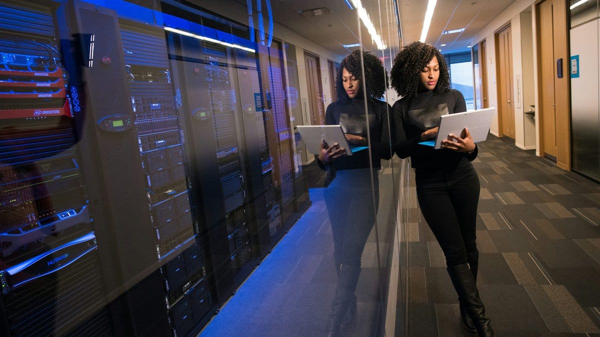 Technology professional working in a modern server room environment