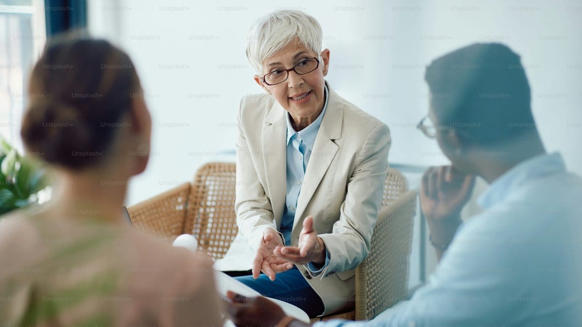 Female financial advisor consulting with clients in an office setting