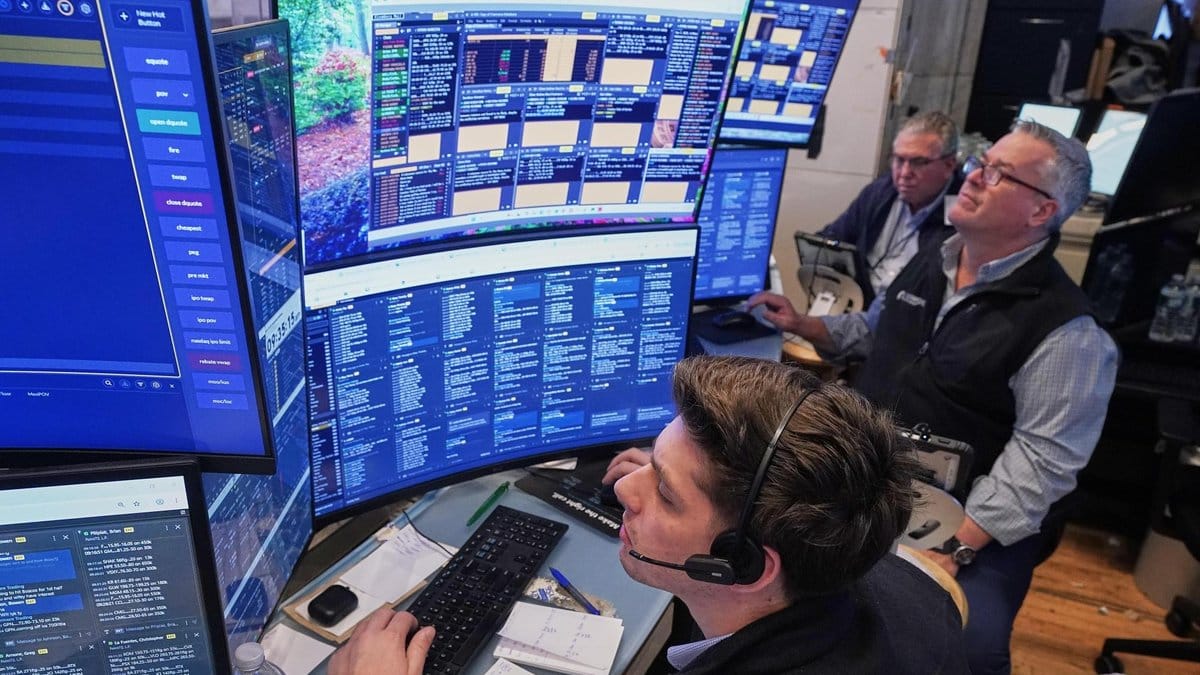 Financial analysts monitoring stock market data screens
