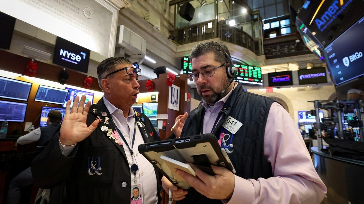 Wall Street traders discussing market trends on the floor of the New York Stock Exchange ahead of the FOMC meeting