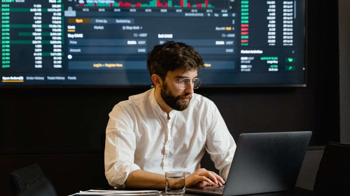 A financial analyst reviewing precious metals market data on a trading screen