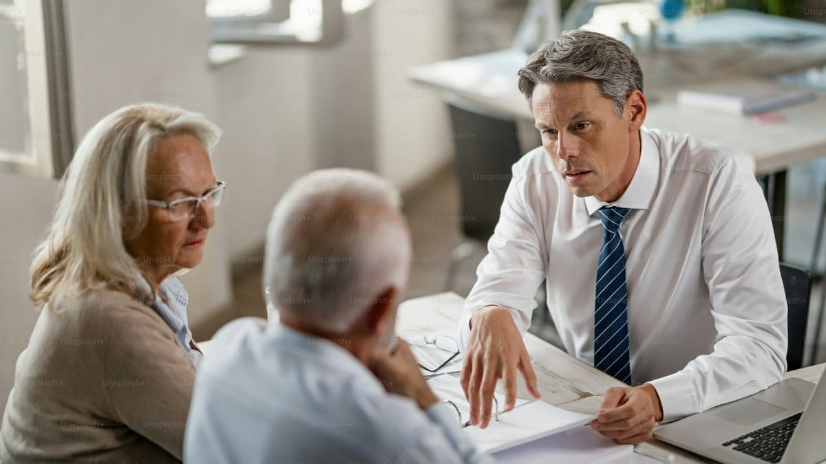 Financial advisor discussing retirement plans with a senior couple