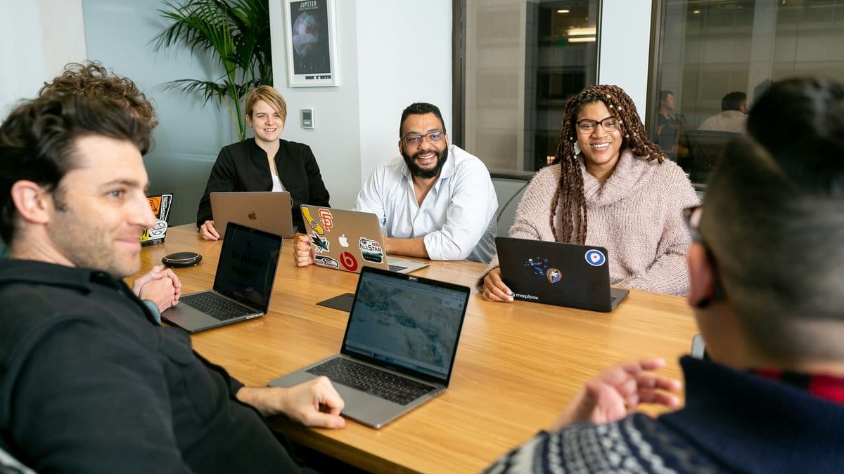 Diverse technology team collaborating in a modern boardroom setting