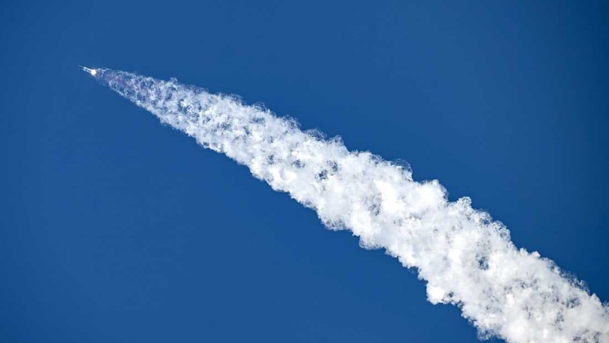 SpaceX Falcon 9 rocket ascending into blue sky leaving a white contrail