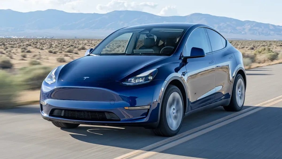 Tesla Model Y driving on highway showcasing autonomous driving capabilities