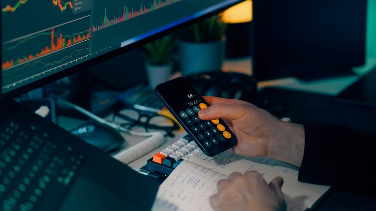 Market analyst reviewing stock charts and calculations during the July 2026 technology selloff
