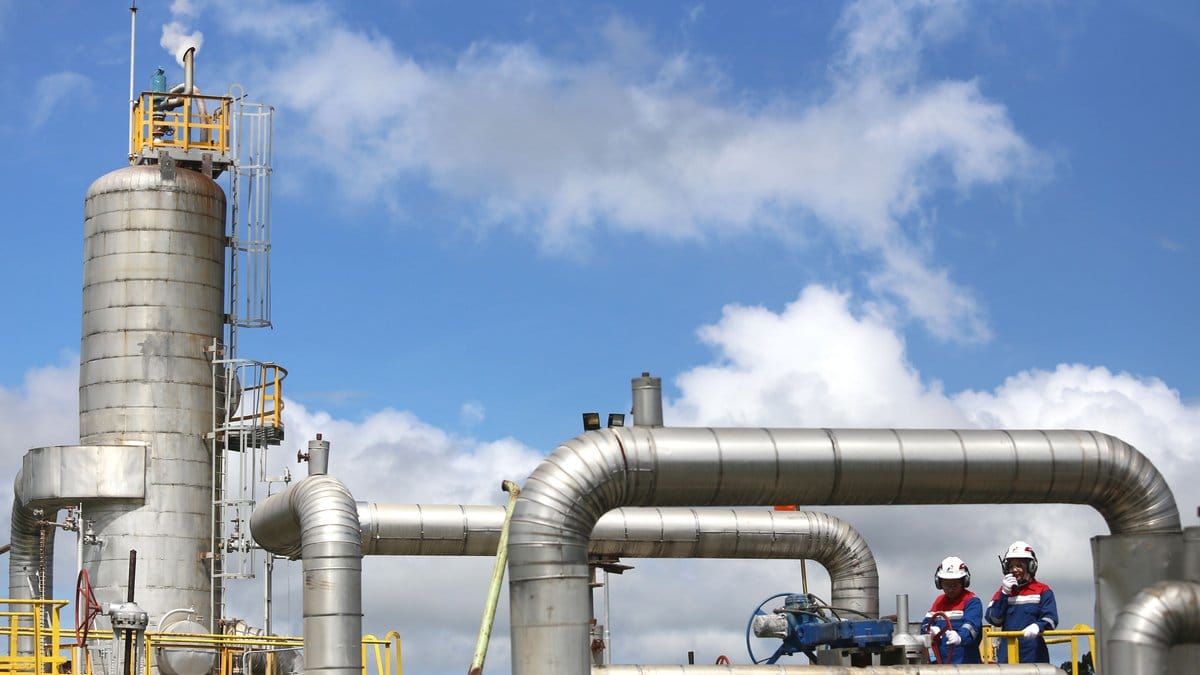 Oil and gas processing facility with industrial workers