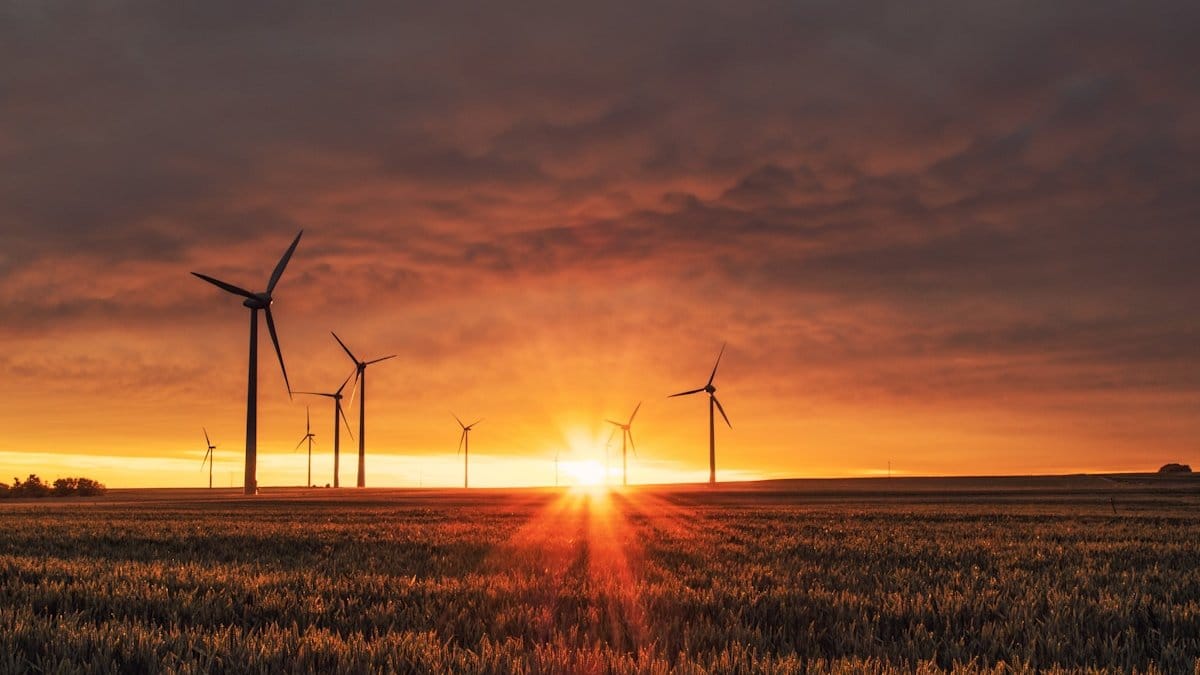Wind turbines and solar panels representing the global renewable energy transition