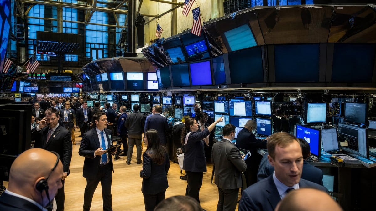 Traders work on the floor of the New York Stock Exchange during an active trading session