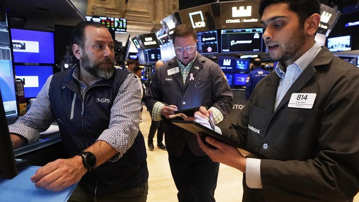 Traders working on the floor of the New York Stock Exchange as markets react to Fed policy signals