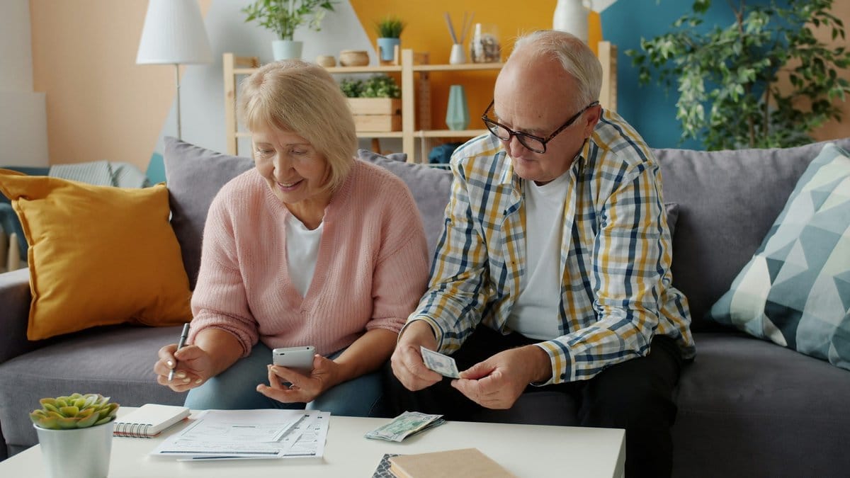 Retired couple reviewing a household income plan at home