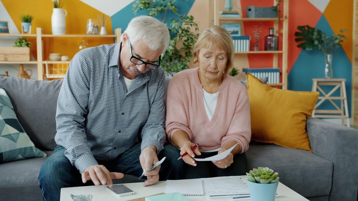 Older couple reviewing retirement savings paperwork at home