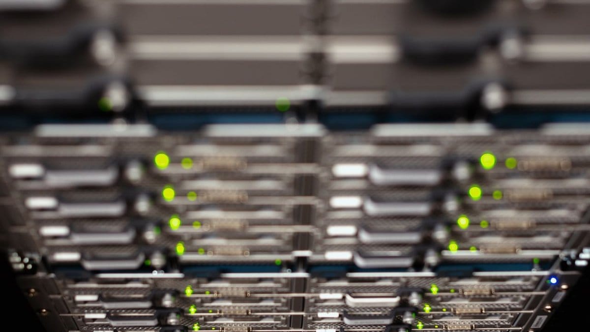 Close-up of server hardware with green indicator lights in a data center