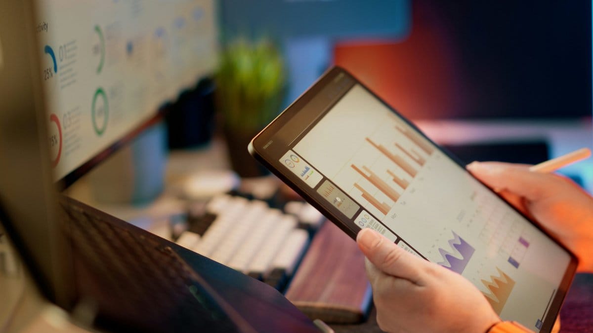 Financial analyst reviewing market data on a tablet