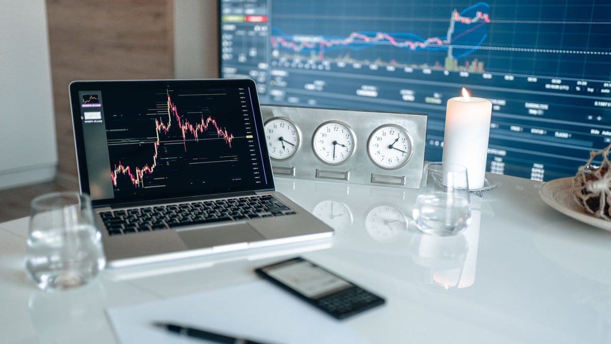 Financial trading workstation with market charts and global clocks