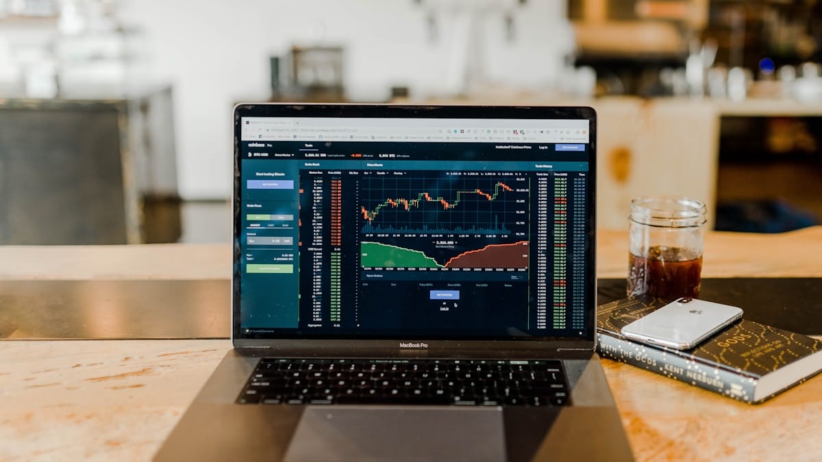 Cryptocurrency trading platform displayed on a laptop computer in a modern workspace