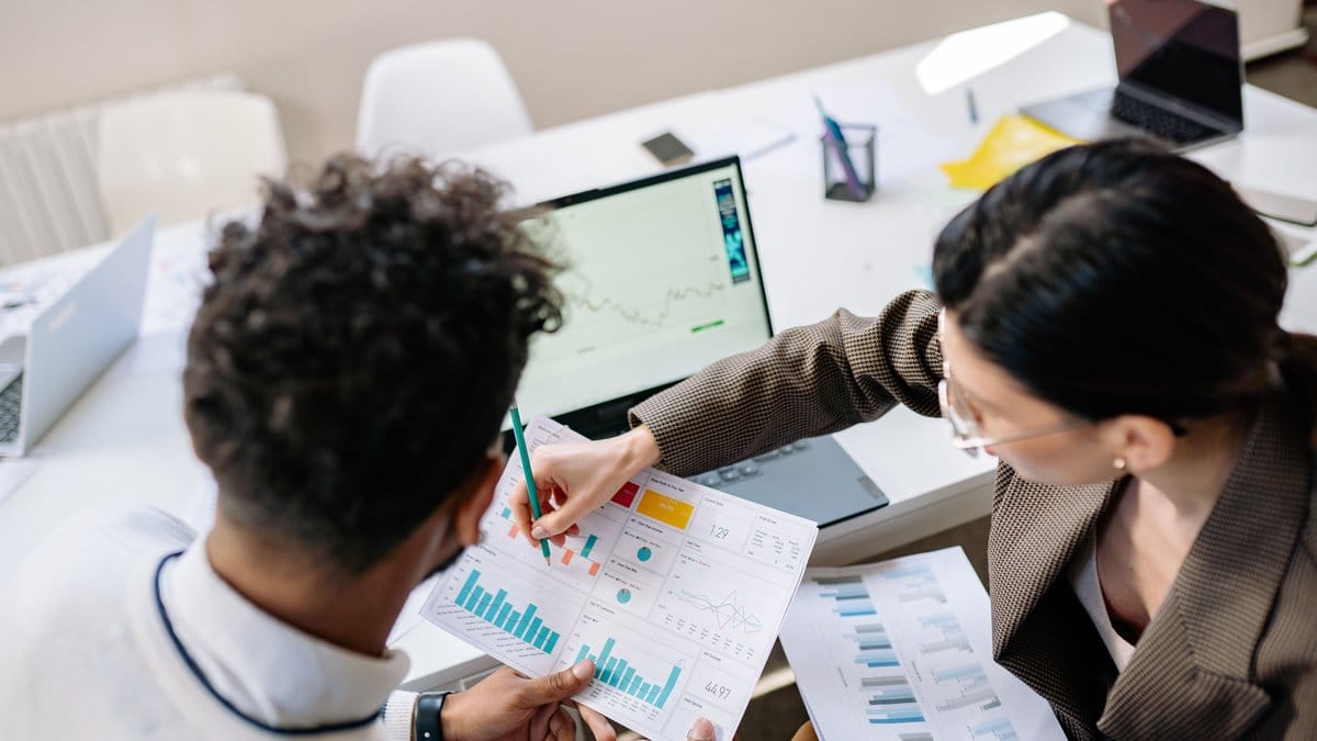 Diverse financial analysts reviewing economic data and Treasury yield movements in a professional market research office