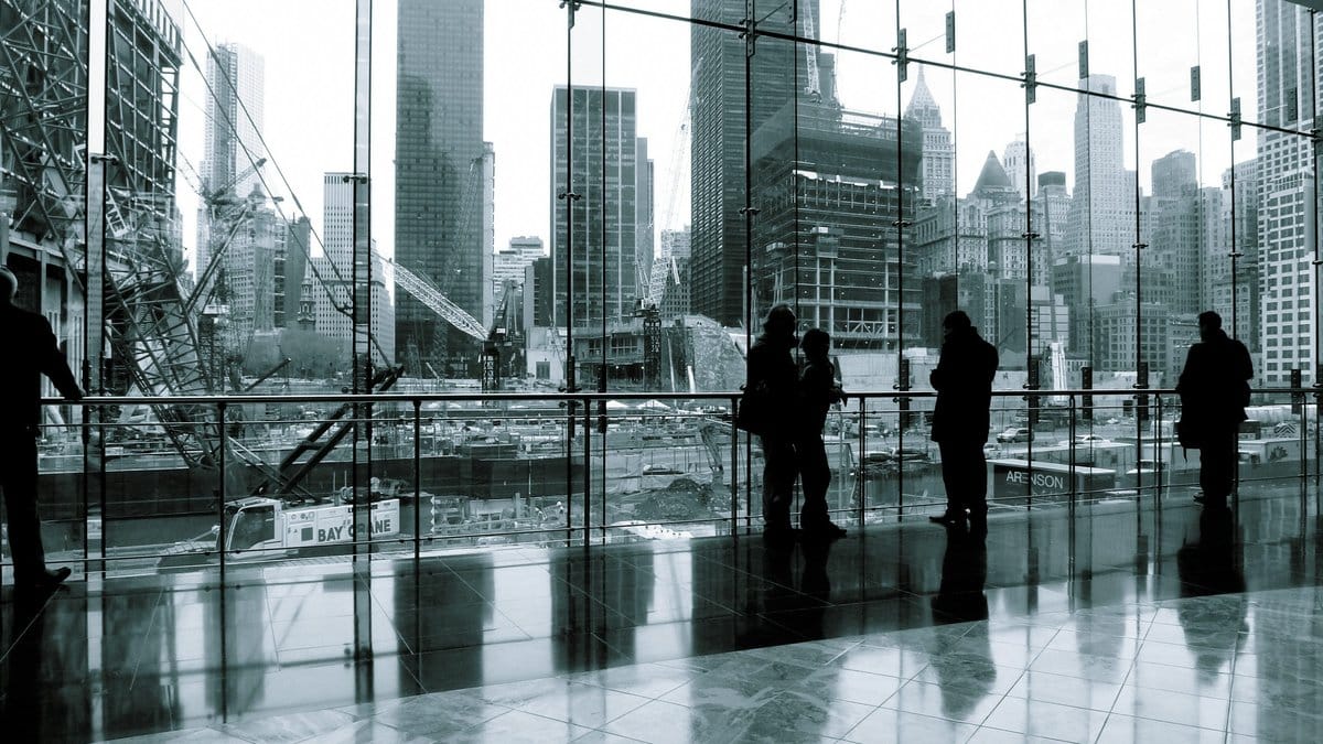 Professionals standing inside a financial district with a city skyline