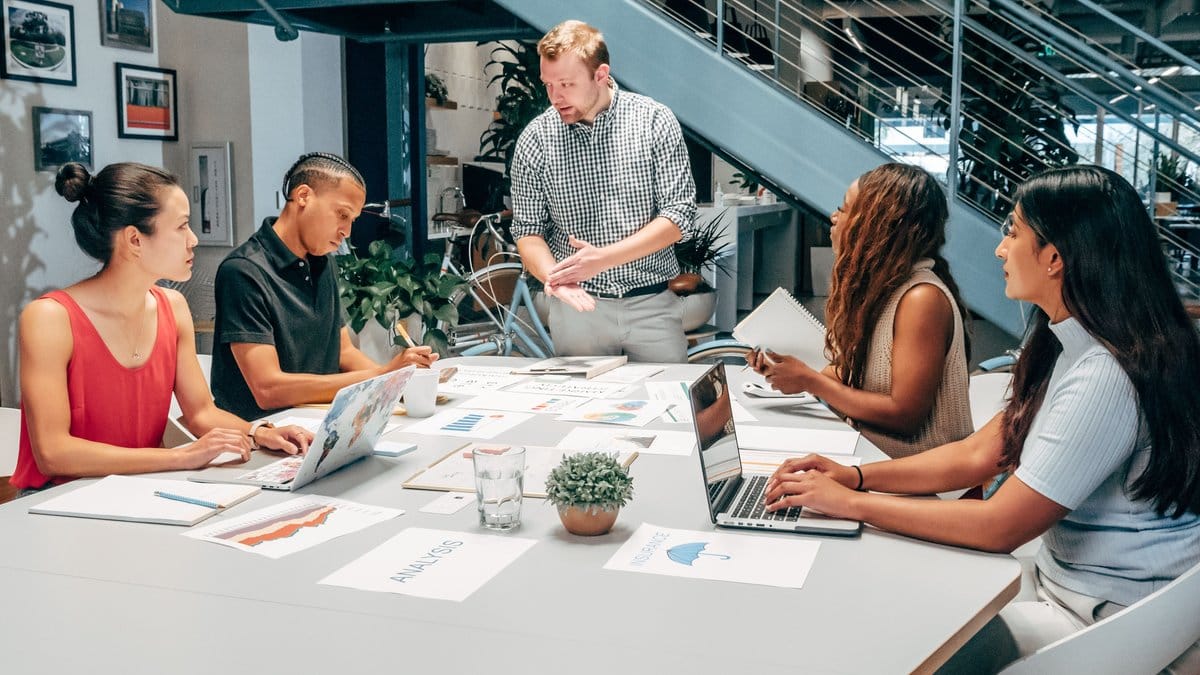 Diverse business team reviewing financial planning documents in a modern office
