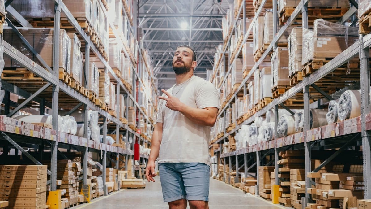 Shopper walking through a high-volume wholesale warehouse aisle
