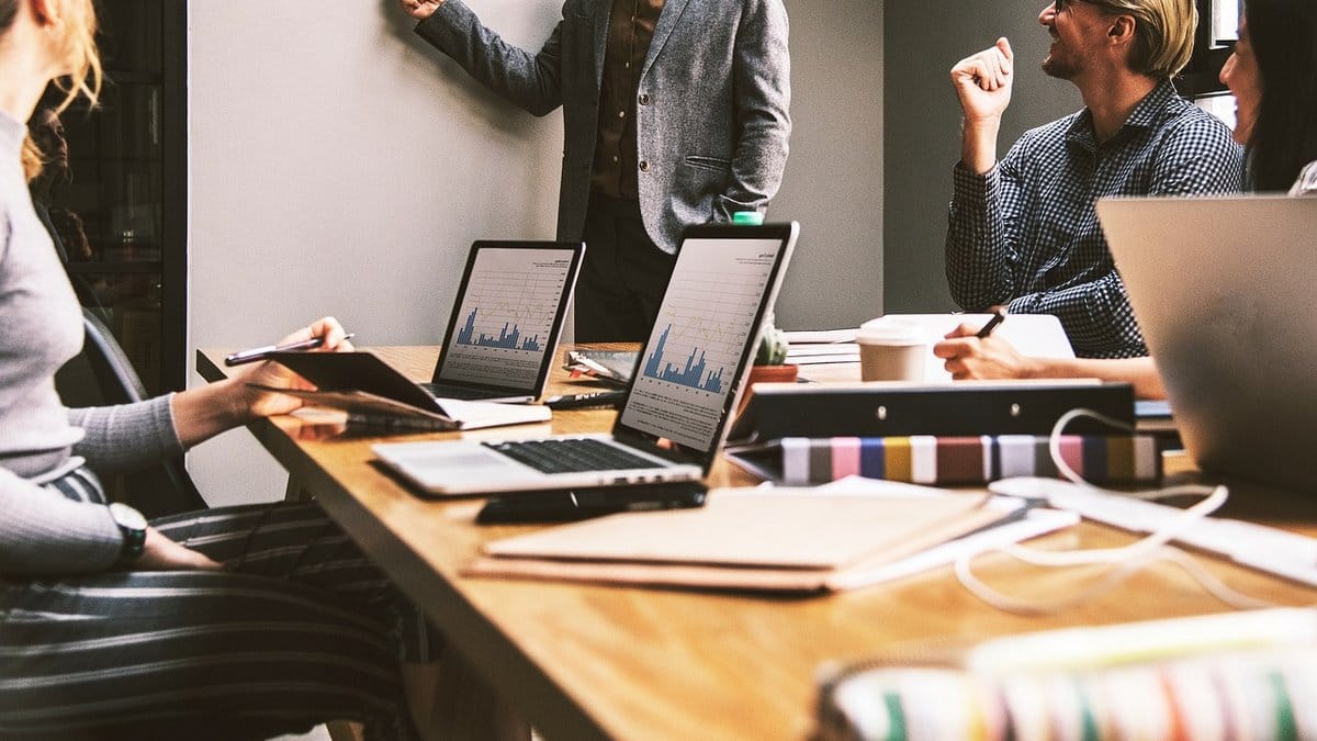 Financial professionals reviewing market data during an office meeting