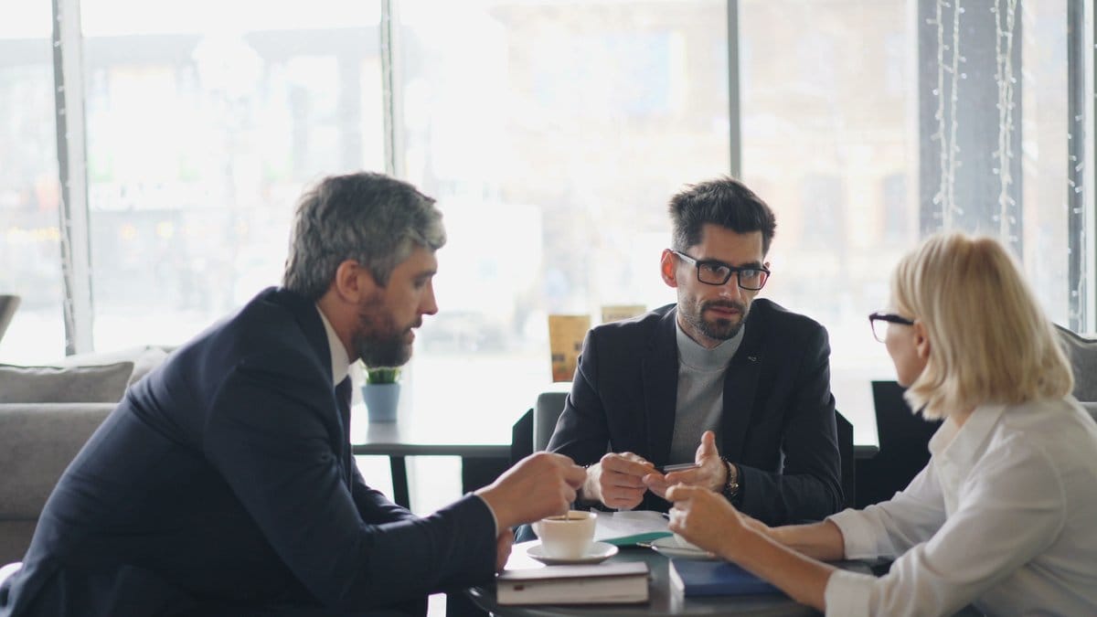 Business professionals meeting to evaluate financial markets, corporate earnings, and investment outlook