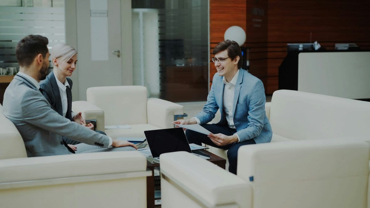 Financial advisors reviewing market strategy and investment documents in a modern office.