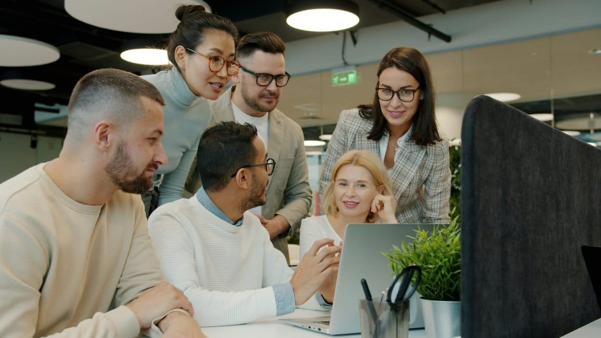 Diverse financial analysts reviewing global market conditions in a modern office