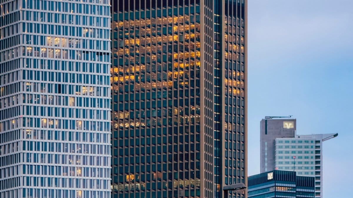 Modern financial district office towers representing global capital markets and higher-rate conditions