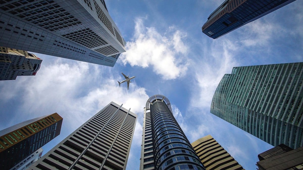 Modern financial district skyscrapers viewed from street level, representing global capital markets