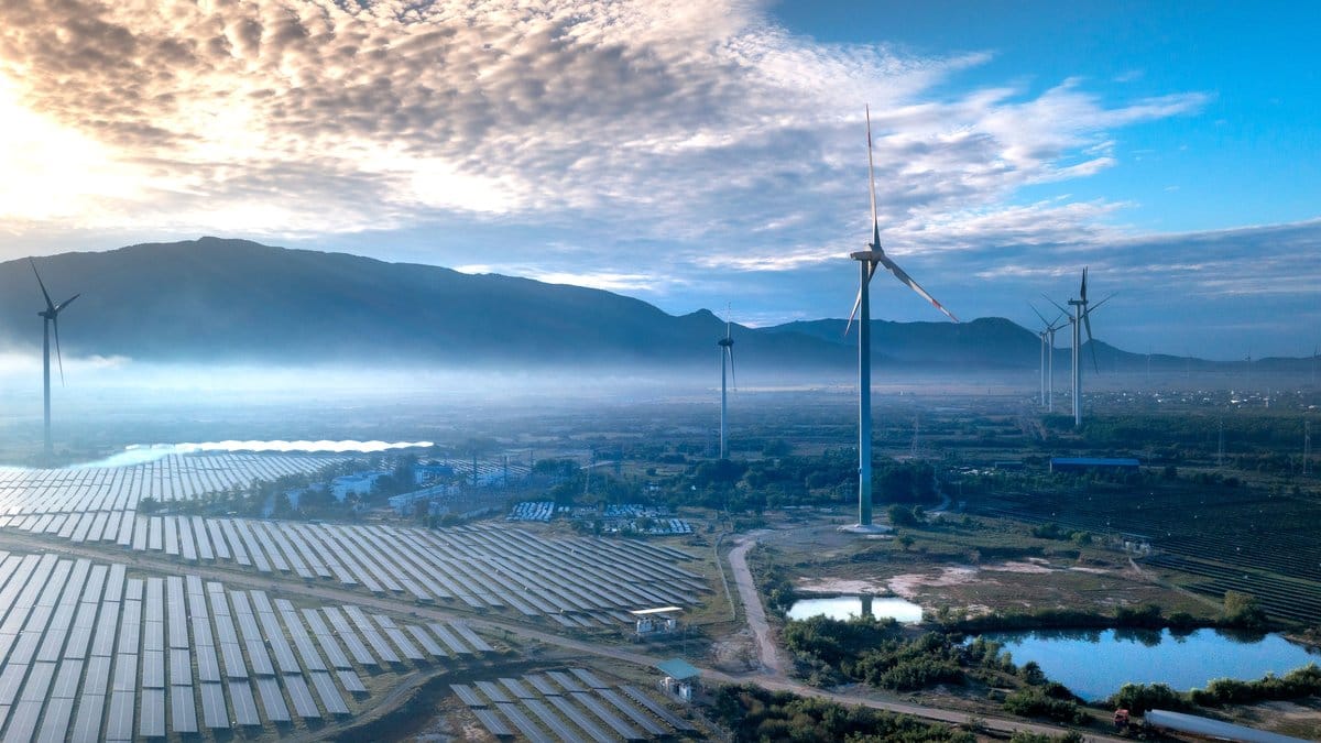 Solar panels and wind turbines at a renewable energy facility