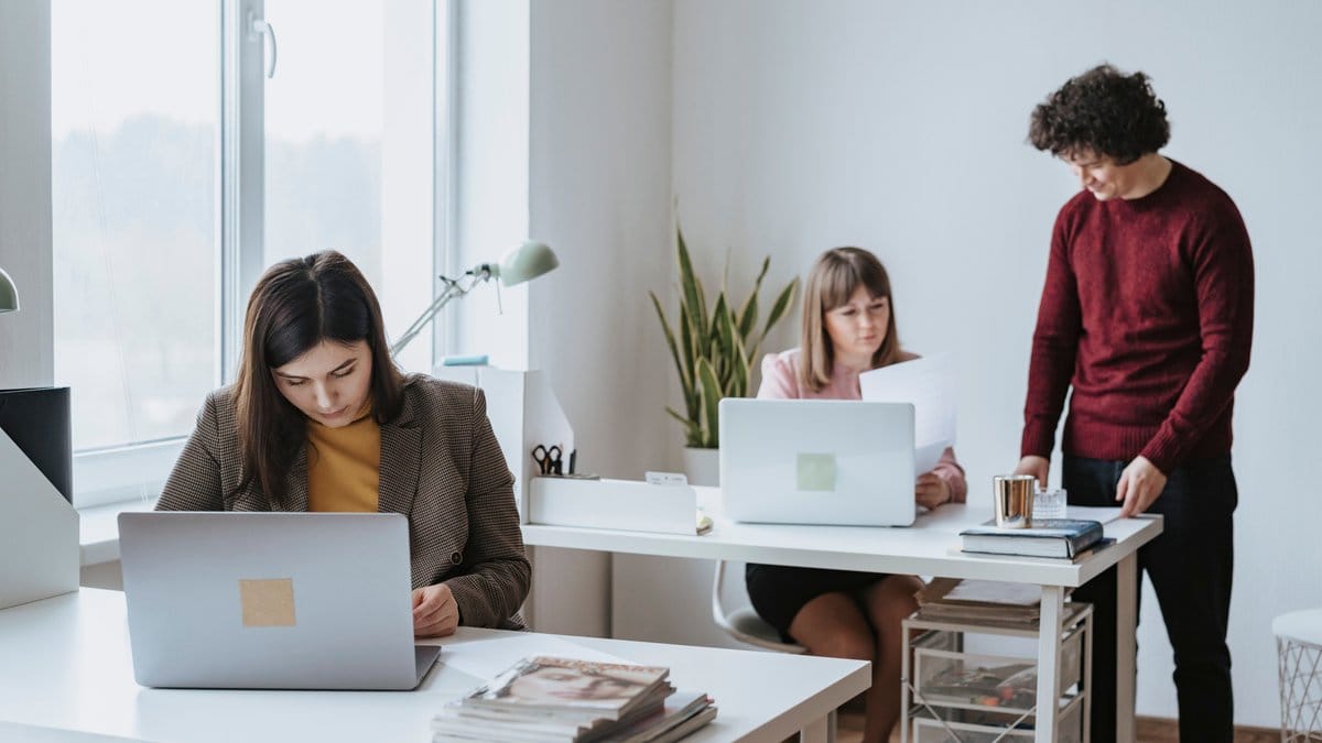 Diverse financial professionals reviewing market information in a bright office