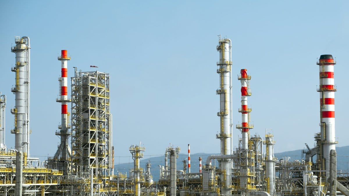 Oil refinery infrastructure representing energy markets, inflation pressures and global supply risk