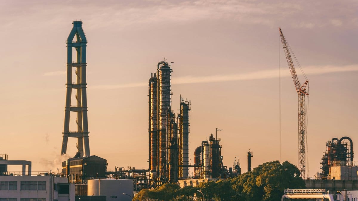 Aerial view of oil refinery representing global crude market supply risk