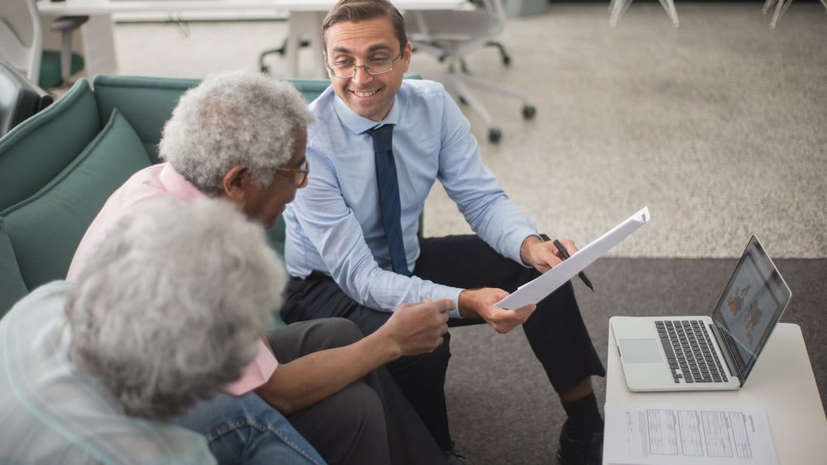 Retired couple meeting with a financial advisor to plan retirement income
