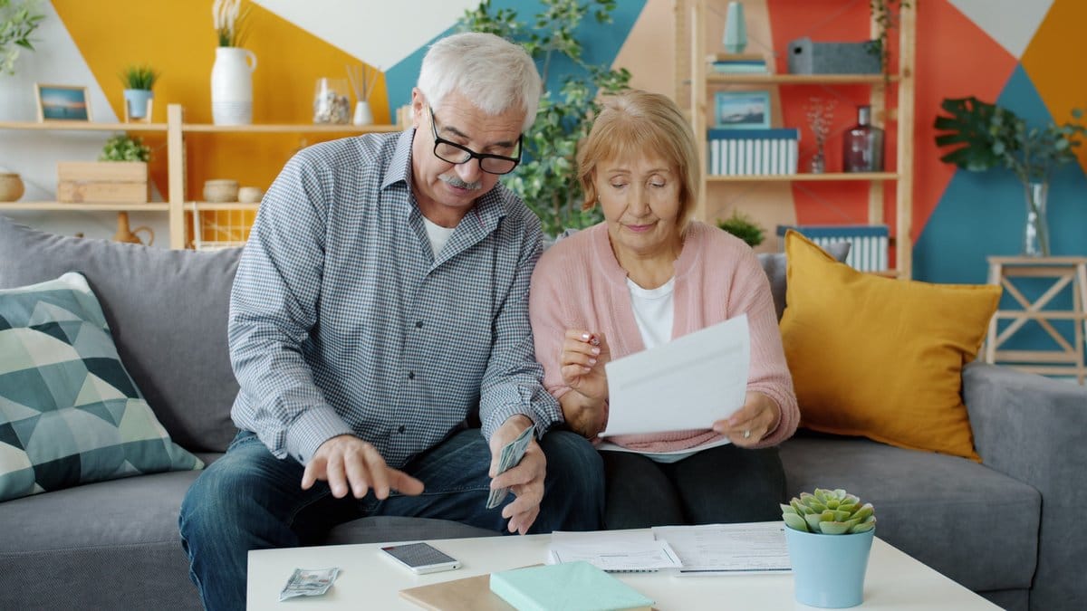 Older couple reviewing retirement finances and household documents at home