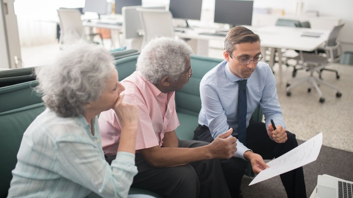 Retirement planning consultation with an older couple and financial advisor