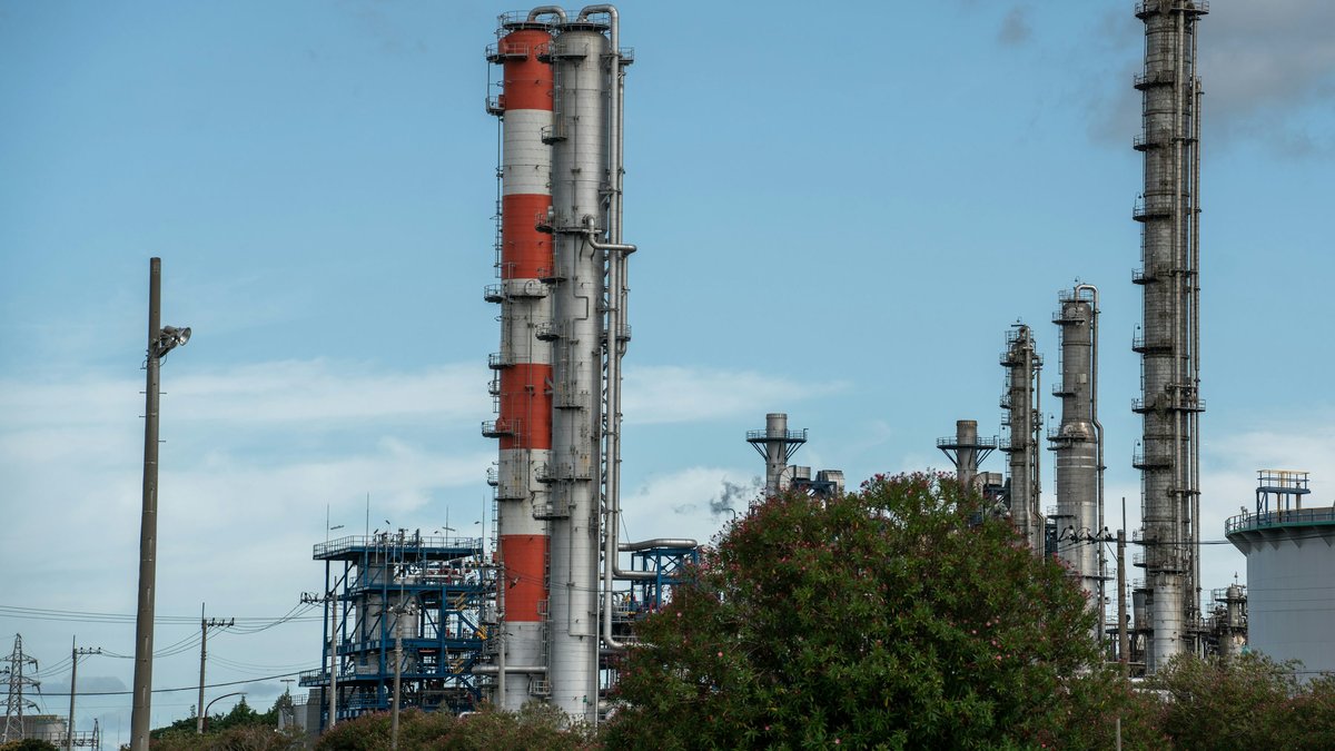 Oil refinery towers illustrating energy prices and inflation risks in the October 15, 2026 Daily Market Report