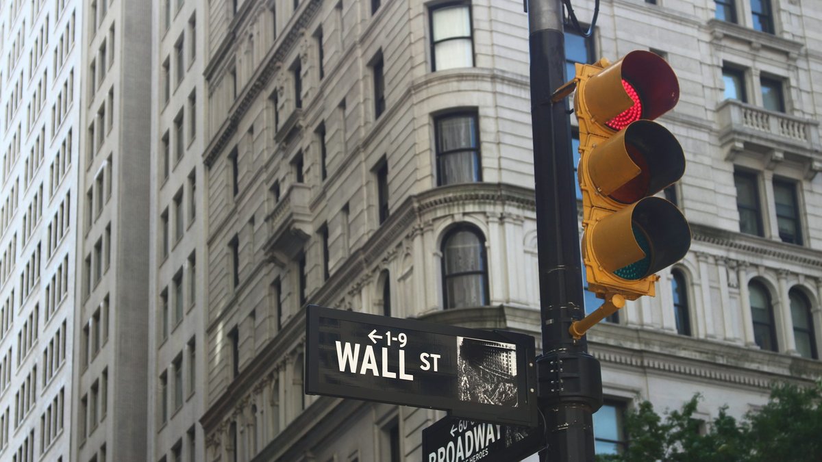 Wall Street financial district intersection representing global equity market activity