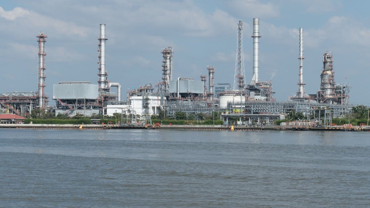 Aerial view of an oil refinery and storage tanks on a bright day