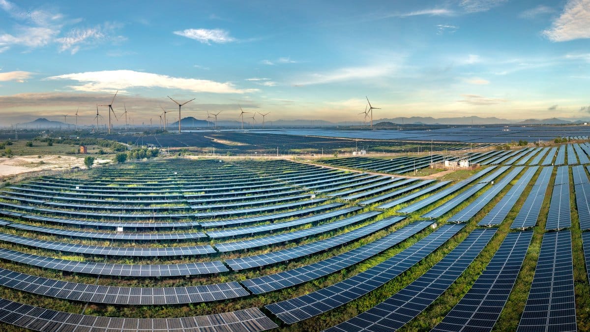 Solar panels and a wind turbine at a renewable energy facility